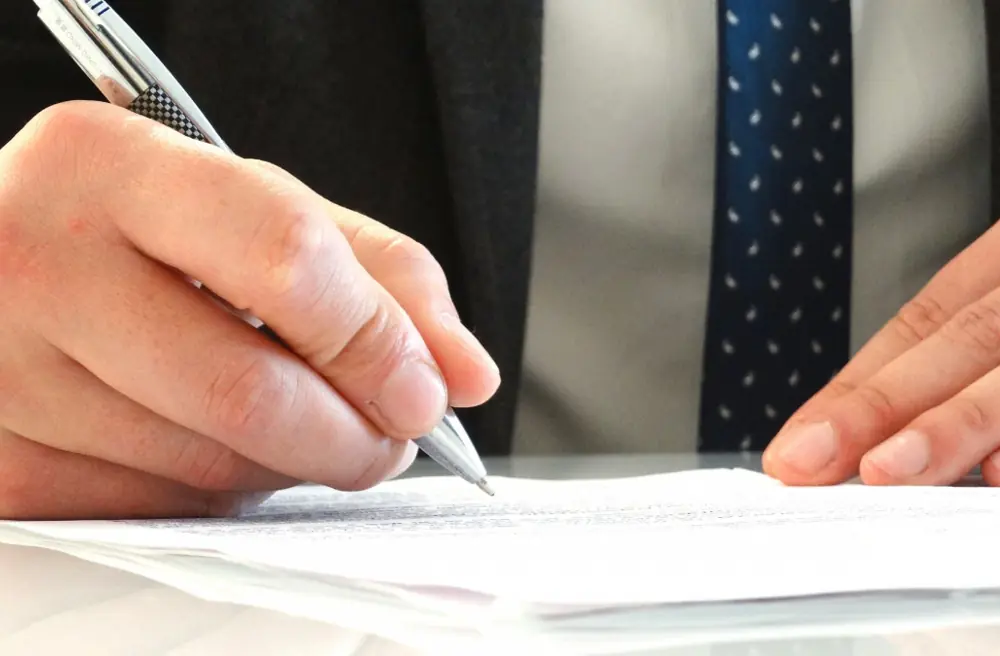 A person signing a printed contract